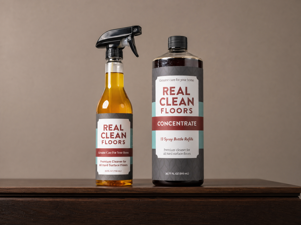 Two bottles of 'Real Clean Floors' cleaning products on a wooden surface with a neutral background.